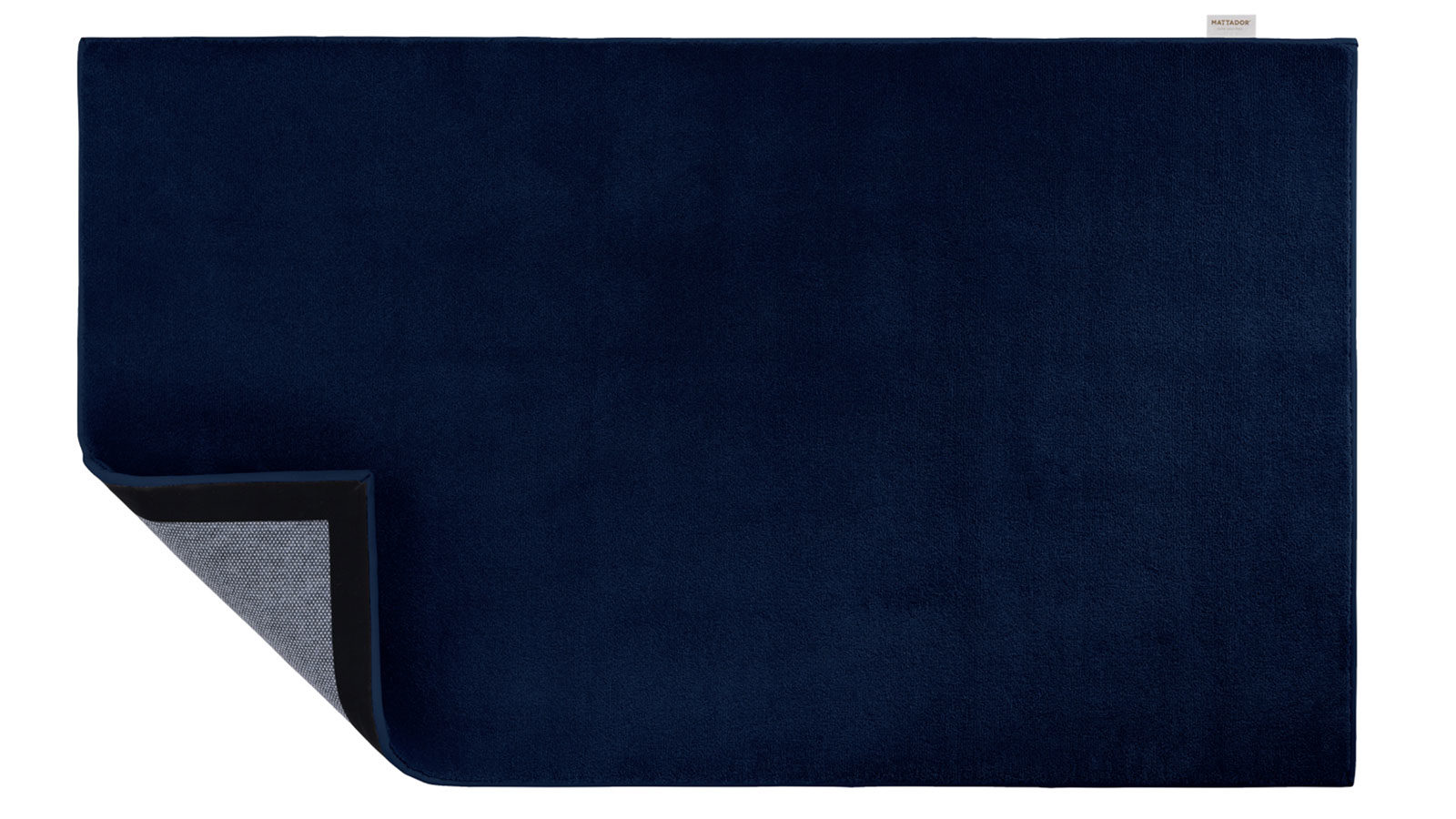 Bovenaanzicht van blauw vloerkleed met in de hoek zicht op de onderkant van de mat